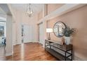 Bright foyer featuring hardwood floors, a stylish table, decor, and a decorative mirror at 9705 Westbury Cir, Highlands Ranch, CO 80129