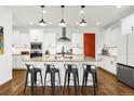 Modern kitchen with white cabinets, granite countertops, and stainless steel appliances at 4706 Mesa Top Dr, Monument, CO 80132
