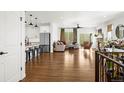 Open-concept living space boasting hardwood floors, a fireplace, and seamless flow into the kitchen at 4706 Mesa Top Dr, Monument, CO 80132