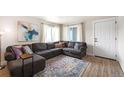 Comfortable living room boasts a sectional sofa, bright windows, and stylish decor at 7937 Chase Cir # 176, Arvada, CO 80003