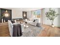 Comfortable living area features a modern fireplace, plush seating, and a large window for plenty of light at 5872 Taft St, Arvada, CO 80004