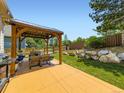 Outdoor patio area with a gazebo and landscaped yard featuring rocks and lush greenery at 5130 Morning Glory Pl, Highlands Ranch, CO 80130