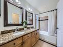 Bathroom with granite countertops, double sinks, and a bathtub with a shower at 5130 Morning Glory Pl, Highlands Ranch, CO 80130