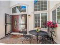 Inviting entryway with a tiled patio, charming seating, and well-lit access to the home's front door at 6328 S Ouray Way, Aurora, CO 80016