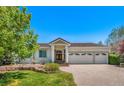 Stunning single-story home with a three-car garage, manicured lawn, and brick-paved driveway at 6328 S Ouray Way, Aurora, CO 80016