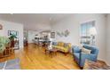 Bright living room with hardwood floors, large windows, and an open concept design at 22674 E Henderson Dr, Aurora, CO 80016