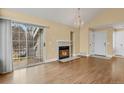 Inviting living room with a cozy fireplace, sliding glass doors, and a chandelier at 13732 E Lehigh Ave # H, Aurora, CO 80014