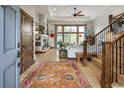 Bright living room featuring hardwood floors, fireplace, and a large window with scenic views at 1654 Muirfield Ln, Evergreen, CO 80439