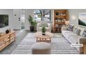 Bright, staged living room featuring modern furniture, neutral colors, and ample natural light at 11422 W 17Th Pl, Lakewood, CO 80215