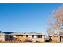 Brick ranch home with a fenced yard and mature trees at 12573 W 8Th Ave, Golden, CO 80401
