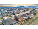 Panoramic aerial view showcasing a large neighborhood with the majestic mountains in the background on a sunny day at 18267 W 95Th Ave, Arvada, CO 80007