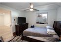 This bedroom has a ceiling fan, one window and a spacious closet with an ensuite bathroom at 201 S Monmouth Ave, Firestone, CO 80520
