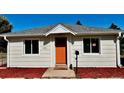Charming home exterior with a bright orange front door, fresh paint, and manicured landscaping for great curb appeal at 601 W Layton Ave, Englewood, CO 80110