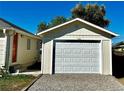 Detached garage with white door, offering ample parking and storage space at 601 W Layton Ave, Englewood, CO 80110