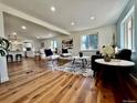 Bright living room with hardwood floors, neutral decor, and natural light from large windows at 601 W Layton Ave, Englewood, CO 80110