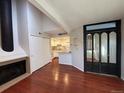 Living room with hardwood floors, a fireplace, and a view into the kitchen at 12484 W Nevada Pl # 210, Lakewood, CO 80228