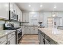 A spacious kitchen featuring stainless steel appliances, granite countertops and sleek cabinets at 1262 High Point Trl, Elizabeth, CO 80107