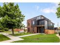Stylish two-story home boasts a modern design with brick and black metal accents, set on a landscaped lot at 4301 Osceola St, Denver, CO 80212