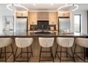 Gourmet kitchen with light wood cabinets, stainless steel appliances, and modern island at 4301 Osceola St, Denver, CO 80212