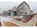 Attractive townhome community featuring contemporary architectural designs and manicured landscaping with snowy front yards at 16102 E 47Th Pl, Denver, CO 80239