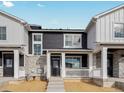 Charming townhome boasts stone accents, white trim, and a welcoming front porch at 6532 N Malaya St, Aurora, CO 80019