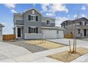 Charming two-story home with a spacious three car garage and well-maintained front yard at 9992 Racine St, Commerce City, CO 80022