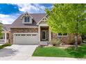 Charming two-story home with a stone facade, attached garage, and well-maintained landscaping at 23420 E Berry Ave, Aurora, CO 80016