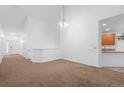 Spacious living room with vaulted ceiling, neutral paint, carpet, and ample natural light at 23420 E Berry Ave, Aurora, CO 80016