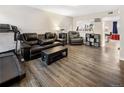 Cozy living room with hardwood floors, comfortable seating, and a bright, open feel at 1264 S Crystal Way, Aurora, CO 80012