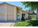 Inviting two-story home with an attached garage, showcasing a well-maintained lawn at 15440 E Oberlin Pl, Aurora, CO 80013