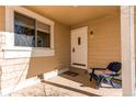 Inviting front porch with a chair and a decorative pillow at 4010 S Rifle Way, Aurora, CO 80013