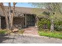 Stone accent wall with brick pathway leading to grand entrance at 6 Martin Ln, Englewood, CO 80113