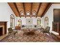 Elegant living room with wooden ceilings, fireplace, and plush seating at 6 Martin Ln, Englewood, CO 80113