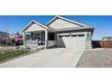 Attractive home with a covered porch and two-car garage, showcasing a well-maintained exterior at 965 Peach Leaf Ln, Elizabeth, CO 80107