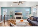 Bright living room with stylish decor, a cozy fireplace, and a large flat-screen TV at 965 Peach Leaf Ln, Elizabeth, CO 80107