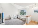 Spacious living area with vaulted ceilings, large window, and plush carpeting for a comfortable feel at 5129 Pasadena Way, Broomfield, CO 80023