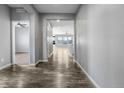 Inviting hallway features beautiful hardwood floors and neutral paint at 6932 E 133Rd Ave, Thornton, CO 80602