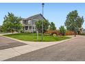 Well-maintained home exterior featuring a green lawn, mature trees and a corner lot at 8522 S Dudley St, Littleton, CO 80128