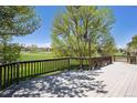Relax on the deck, enjoying panoramic views of lush greenery and fairways at 1105 Oakhurst Dr, Broomfield, CO 80020