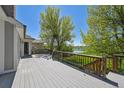Enjoy breathtaking views from the spacious back deck overlooking lush greenery and a serene pond at 1105 Oakhurst Dr, Broomfield, CO 80020