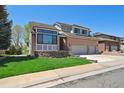 Well-maintained two-story brick home features a manicured lawn and a spacious driveway leading to an attached garage at 1105 Oakhurst Dr, Broomfield, CO 80020