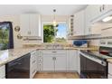 Updated kitchen with stainless steel appliances, white cabinets, and granite countertops at 2251 Cliffrose Ln, Louisville, CO 80027