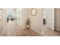 Inviting hallway featuring wood floors, stylish decor, and seamless transition to the living spaces at 2144 Coyote Mint Dr, Monument, CO 80132