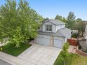 Beautiful aerial view of a two-story home with mature trees and spacious driveway at 4982 S Danube St, Aurora, CO 80015
