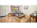 Cozy living room with light hardwood floors and a large window at 4982 S Danube St, Aurora, CO 80015