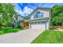 Well-maintained two-story home with a spacious driveway and a green, landscaped lawn at 379 Lincoln Ct, Louisville, CO 80027