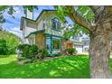Charming two-story home with stone accents, manicured lawn and mature trees at 379 Lincoln Ct, Louisville, CO 80027