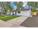Cozy home with fresh exterior paint, driveway, and mature trees at 14317 Olmsted Dr, Denver, CO 80239