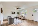 Bright living room featuring stylish furnishings and modern ceiling fan at 14317 Olmsted Dr, Denver, CO 80239