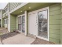 Exterior photo of a townhouse entrance with a storm door and picture window at 12148 E Kepner Pl, Aurora, CO 80012